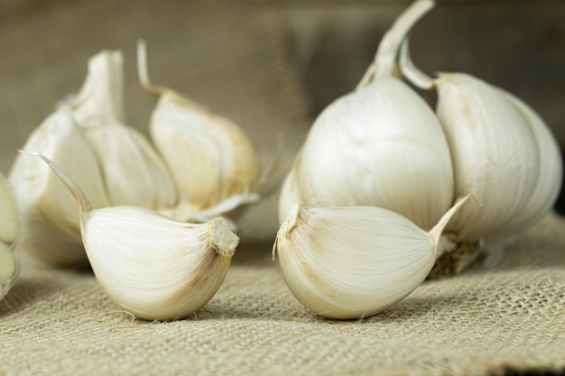 Fresh garlic closeup cloves of garlic on a wooden background