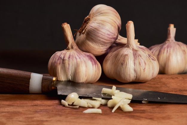 Fresh garlic on a dark wooden background.