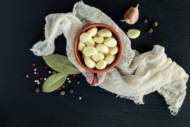 Fresh garlic heads, cloves set on a black stone surface