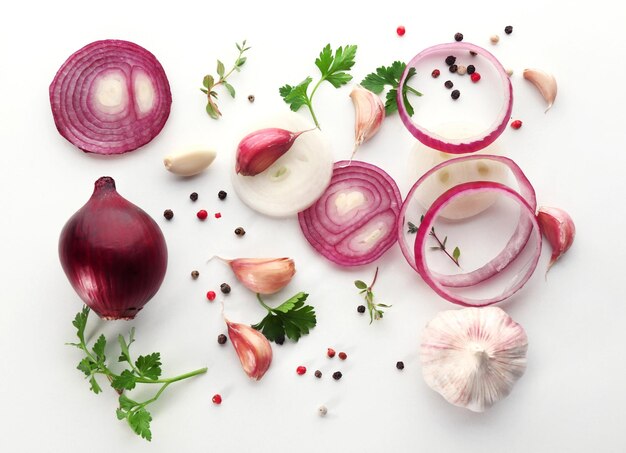 Fresh garlic onion and pepper grains on white background top view