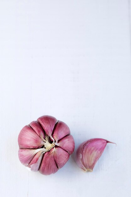 Fresh garlic on white wooden table with copy spacexA