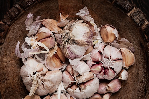 fresh garlic in a wooden plate top view closeup no people