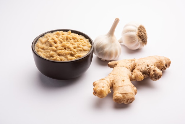 Fresh Ginger and Garlic paste or Adrak Lahsun puree in a ceramic bowl. Selective focus