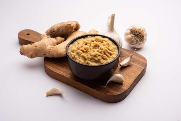 Fresh Ginger and Garlic paste or Adrak Lahsun puree in a ceramic bowl. Selective focus