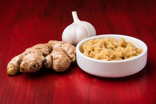 Fresh Ginger and Garlic paste or Adrak Lahsun puree in a ceramic bowl. Selective focus