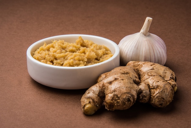 Fresh Ginger and Garlic paste or Adrak Lahsun puree in a ceramic bowl. Selective focus