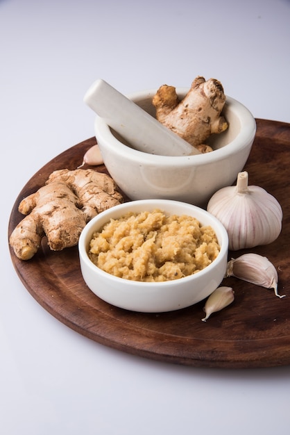 Fresh Ginger and Garlic paste or Adrak Lahsun puree in a ceramic bowl. Selective focus