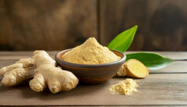 Fresh ginger roots and ginger powder in bowl on wooden table