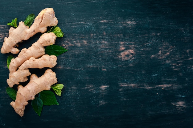 Fresh ginger on a wooden background Top view Copy space