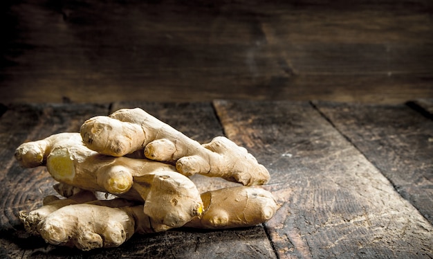 Fresh ginger. On the wooden background