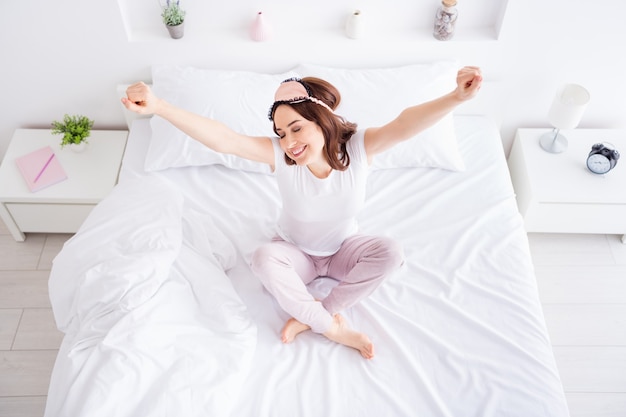 fresh girl sitting in bed waking up