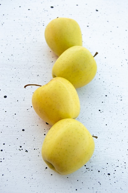 fresh golden apples on a white background