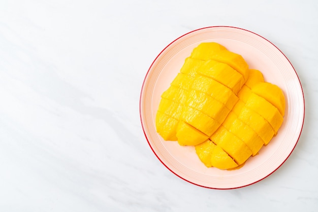 fresh and golden mango sliced on plate