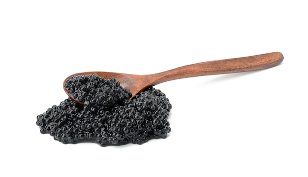 Fresh grainy black paddlefish caviar in brown wooden spoon on white background, close up