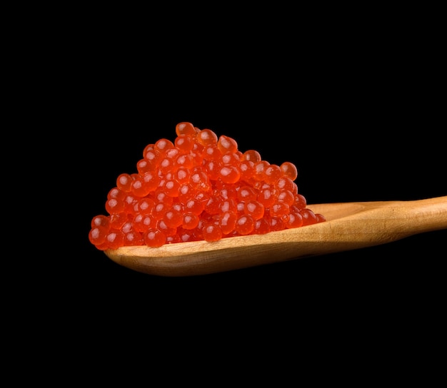Fresh grainy red chum salmon caviar in a wooden spoon, delicious and healthy food,