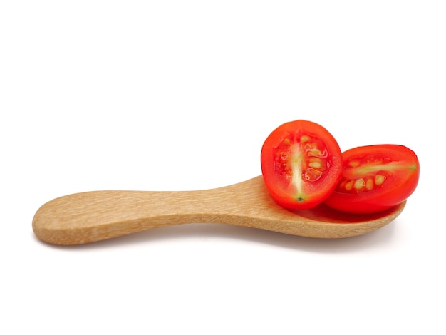 Fresh grape or cherry tomato with wooden spoon on white background.