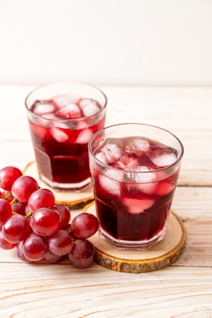 Fresh grape juice on wood background