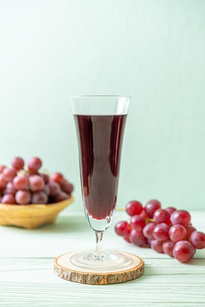 fresh grape juice on wood background