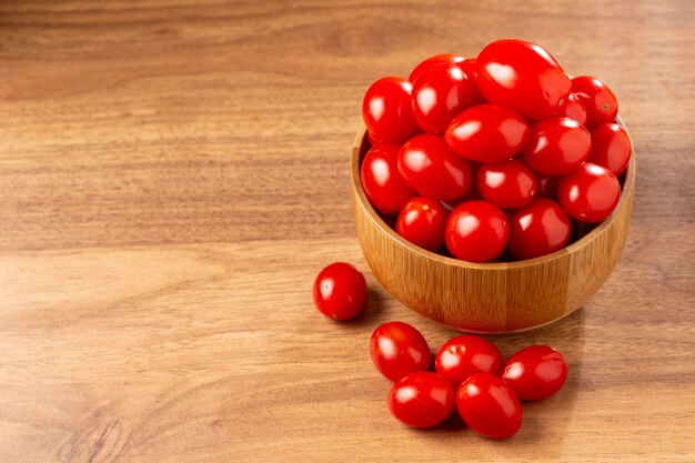 Fresh grape tomatoes in a bowl on the table