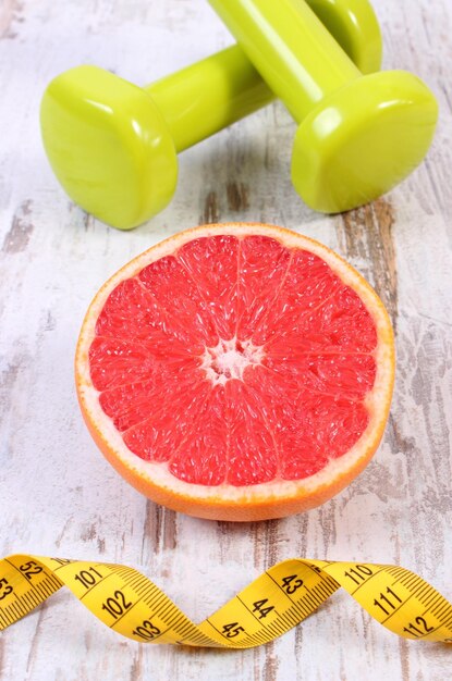 Fresh grapefruit centimeter and dumbbells for fitness healthy lifestyles