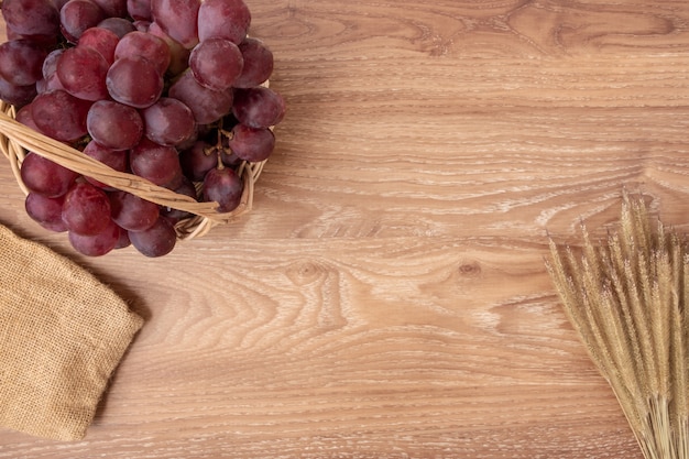 Fresh grapes on basket wood background