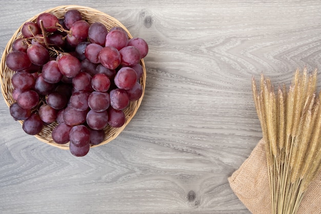 Fresh grapes on basket wood background