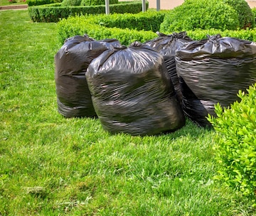 Garbage bags on green yard Stock Photo by ©ekarina 66088493