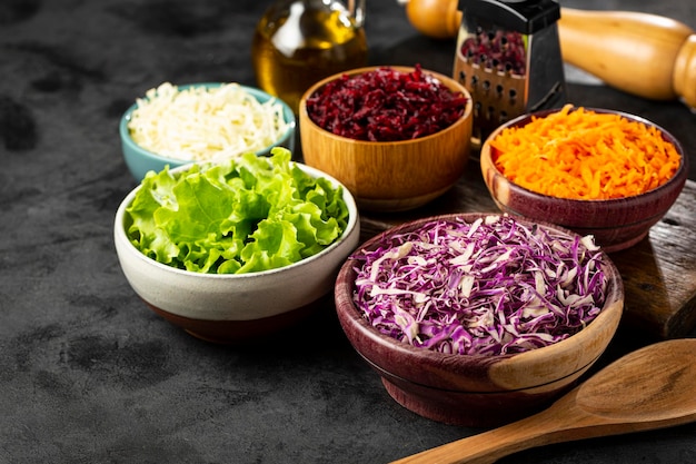 Fresh grated vegetables in bowls on the table Healthy food