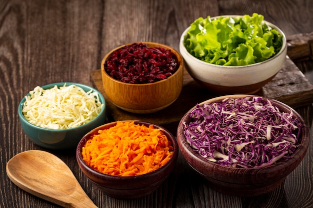 Fresh grated vegetables in bowls on the table Healthy food