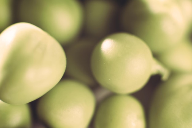 Fresh green appetizing peas on a white background