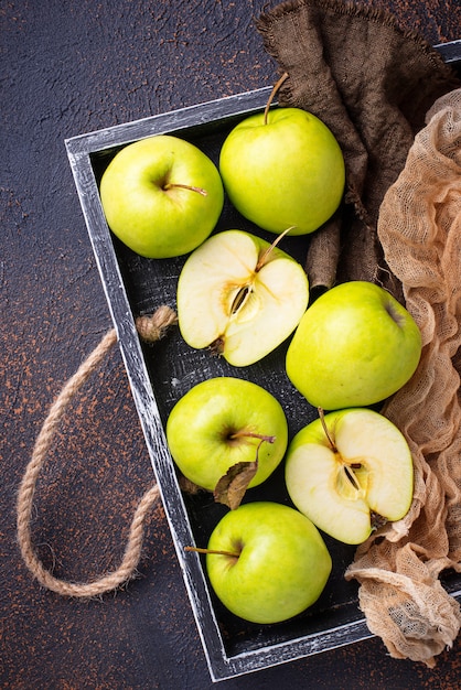 Fresh green apples on rusty background 