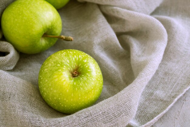 Fresh green apples on the table, close up.