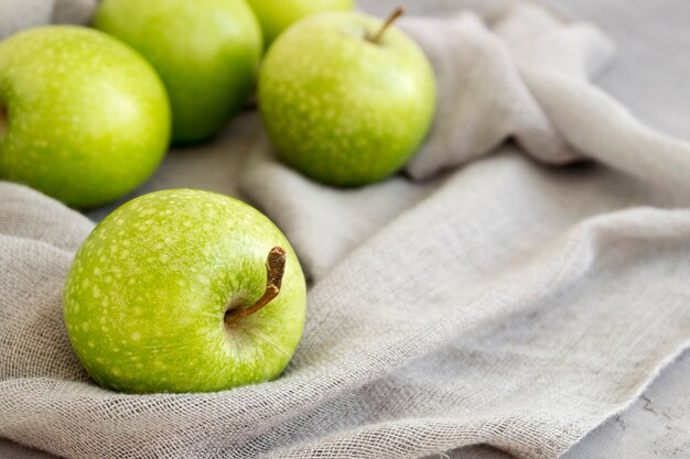 Fresh green apples on the table, close up.