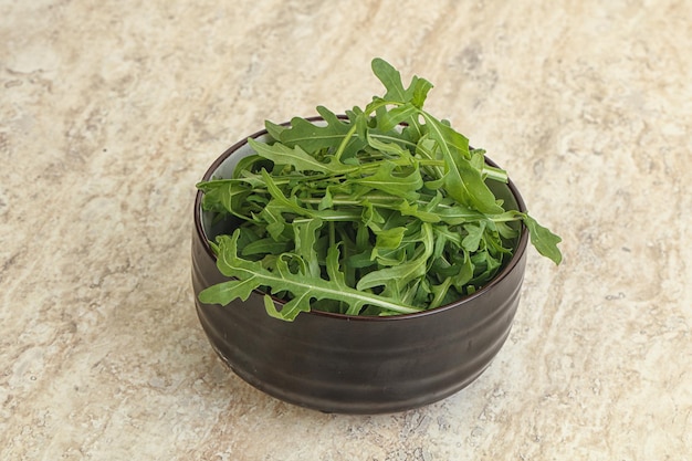 Fresh green arugula in the bowl snack