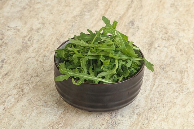 Fresh green arugula in the bowl snack