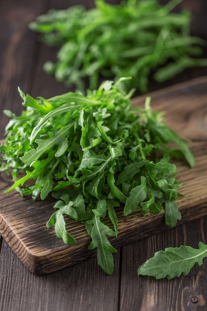 Fresh green arugula in bowl on table. Arugula for salad