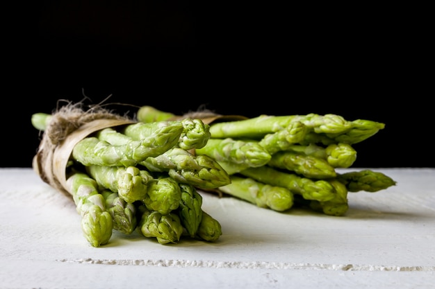 Fresh green asparagus on black background