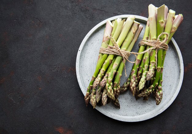 Fresh green asparagus  on black concrete table. Flat lay