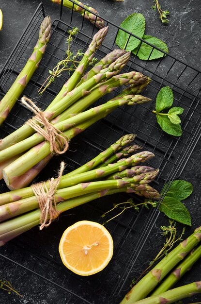 Fresh green asparagus on a black stone background Healthy food Top view free copy space