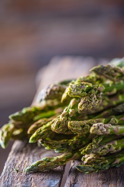 Fresh green asparagus lying on a wooden box.