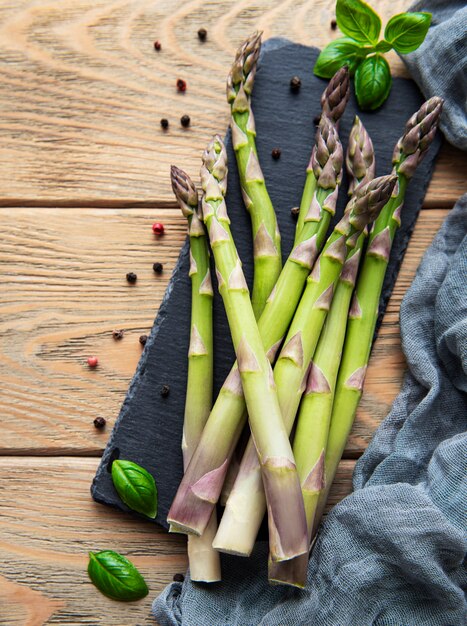 Fresh green asparagus on old wooden table. Flat lay