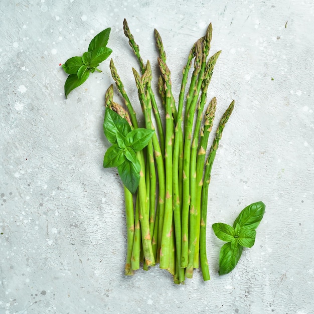 Fresh green asparagus in on a stone background Healthy food Top view