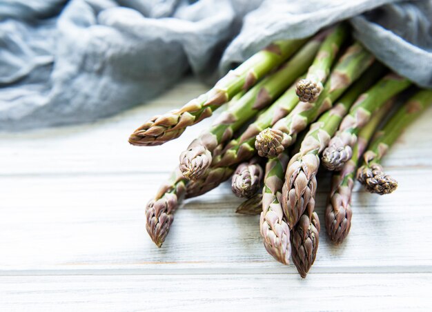 Fresh green asparagus on a white table