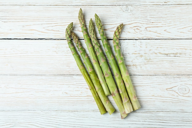 Fresh green asparagus on white wooden