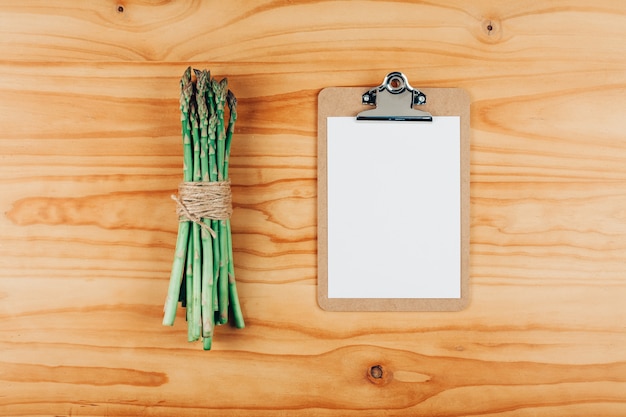 Fresh green asparagus with paper clipboard background