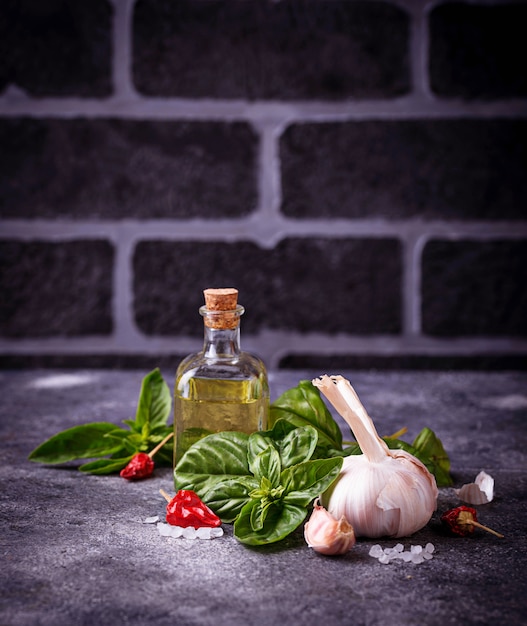 Fresh green basil with garlic and olive oil. Selective focus