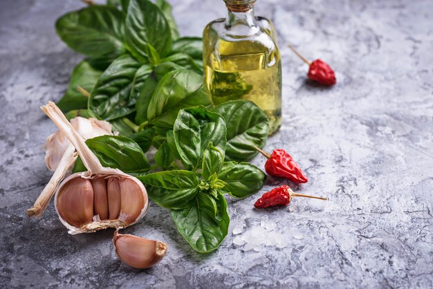 Fresh green basil with garlic and olive oil. Selective focus