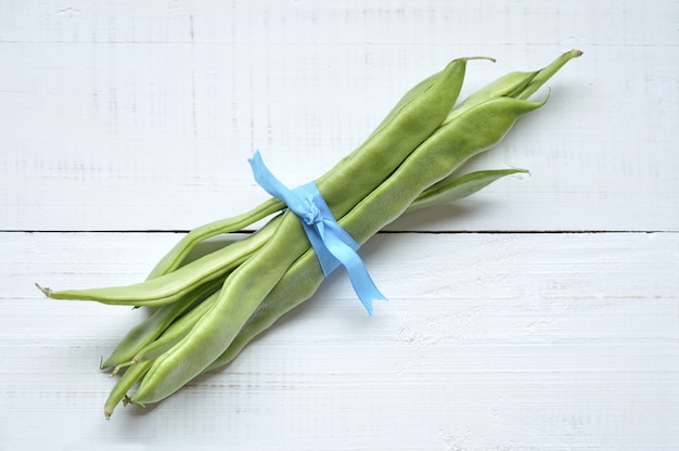 Fresh green beans on a wooden table