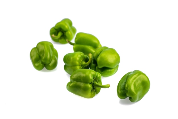 Fresh green bell pepper or capsicum on a white