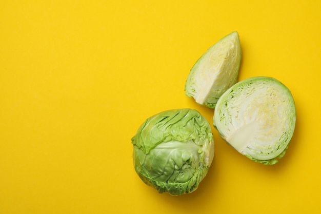 Fresh green cabbage on yellow